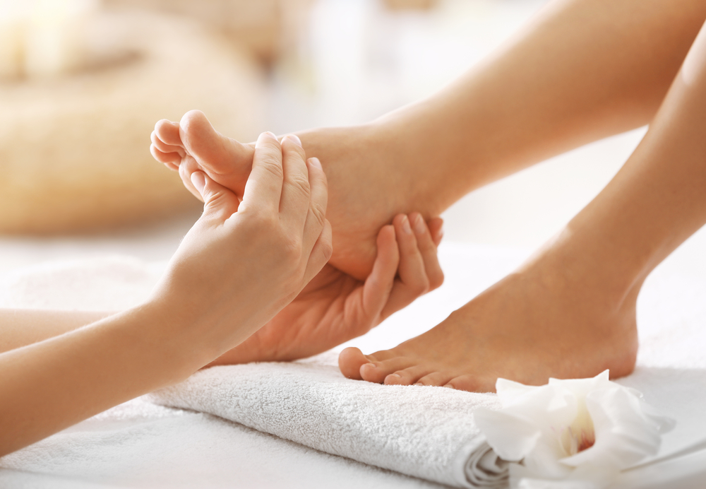 Foot massage in spa salon, closeup